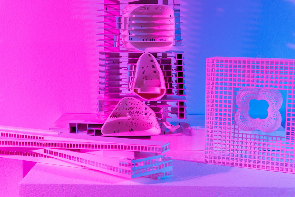 Student model lit cross-lit in blue and pink hues.