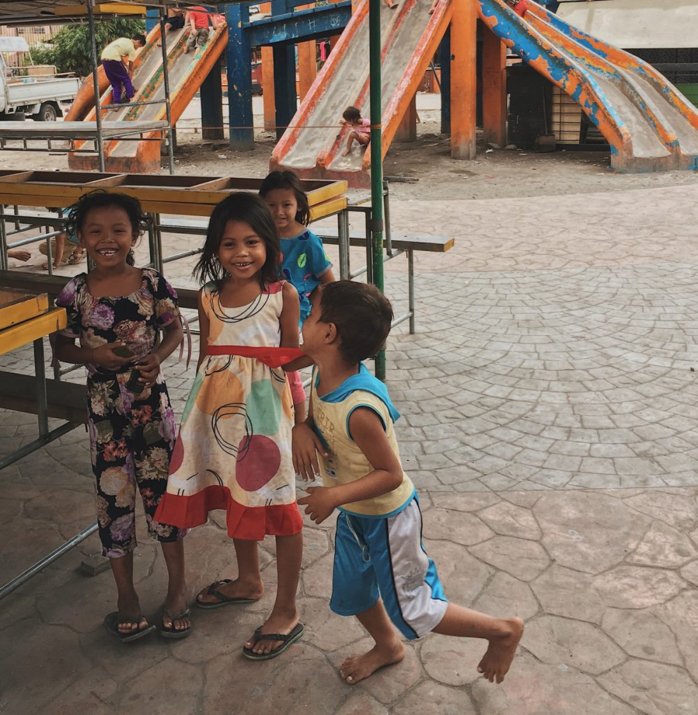 Children smile at a local playground. 