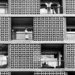 Abstract building with people on balconies