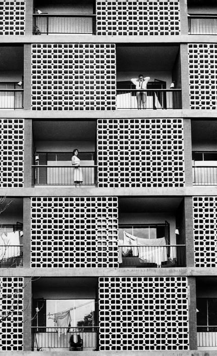 Abstract building with people on balconies