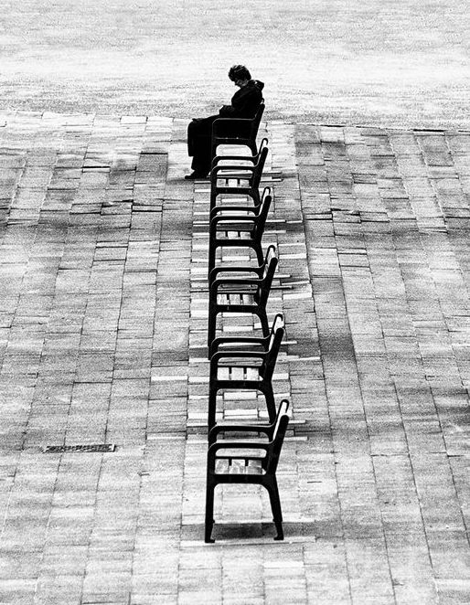 Person sitting alone on a park bench