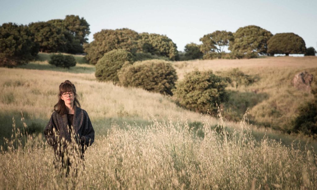 Jenny Odell standing in a field