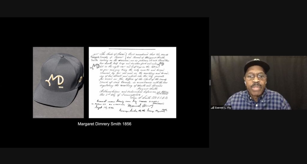 Screenshot of a presentation by Everett Fly on Zoom. Fly is visible on the right side of the image. The presentation shows a hat made by Fly with a design based on a brand by a female Black cattle rancher.