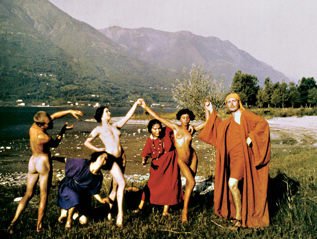 Rudolf von Laban and his dancers posing in a field Ascona in 1914