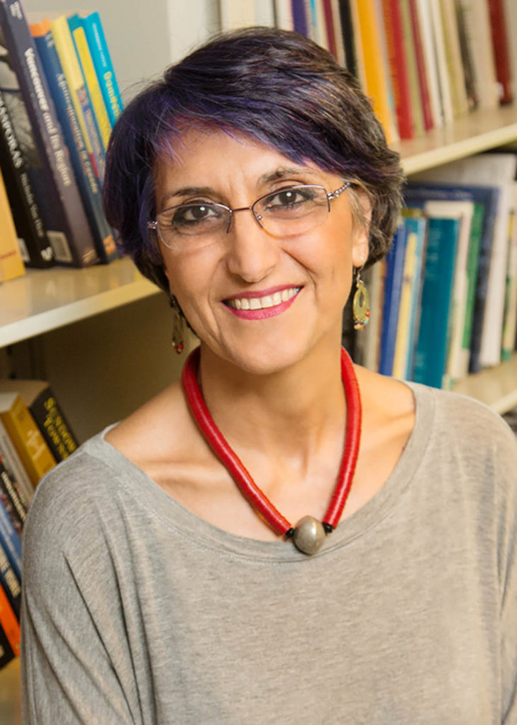 Headshot of Faranak Miraftab, who has short hair and wears glasses, along with a red and gold necklace.