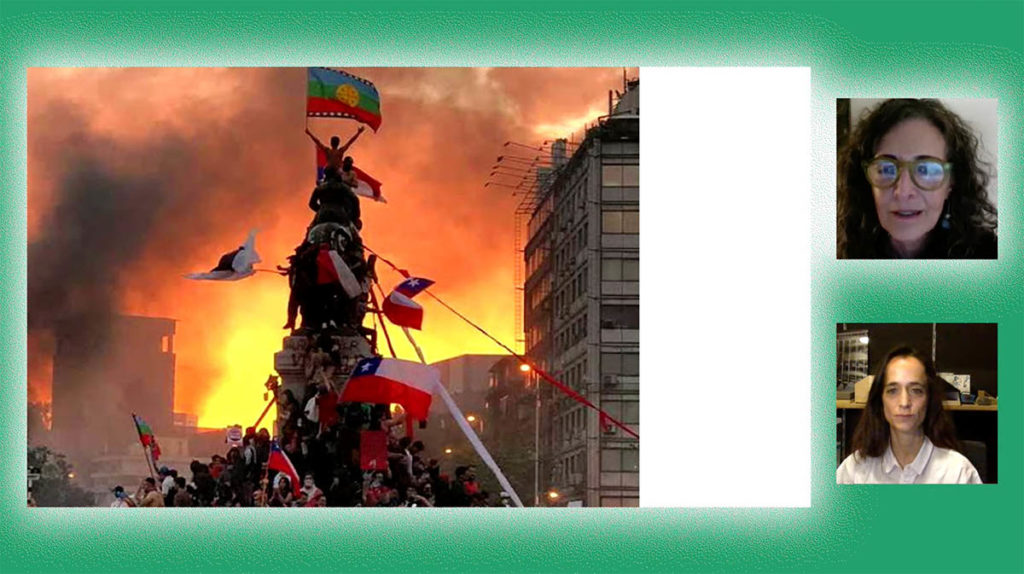 Screenshot from a virtual event. Cecilia Puga and Paula Velasco appear in two small squares on the right. A larger rectangle contains their PowerPoint presentation, which shows a photo from protests in Chile, with a tower of people and a burning fire in the background. There is a bright green background behind Cecilia, Paula, and the PowerPoint.