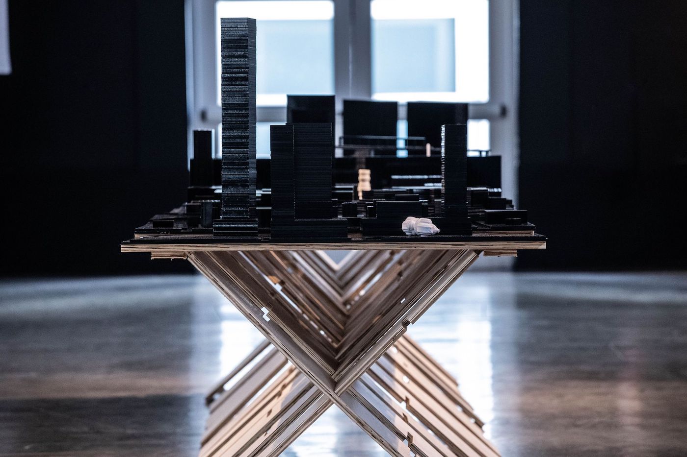 Architecture exhibition with building models on a table.