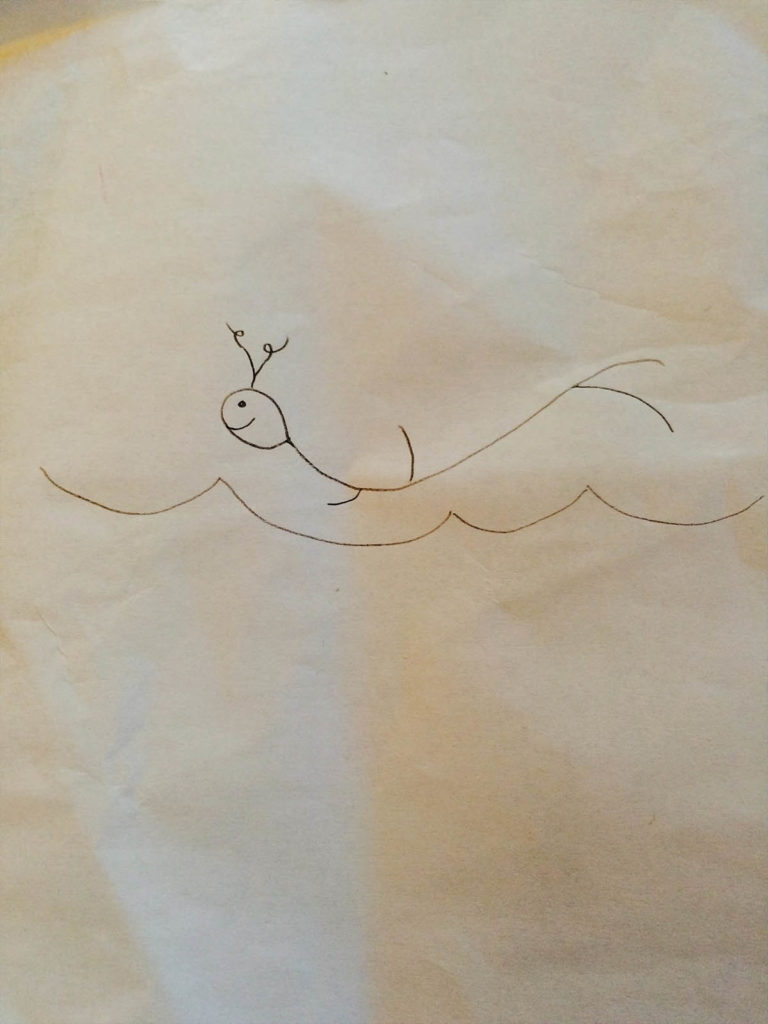 Line drawing on paper of a squiggly stick figure who appears to me flying over an ocean.