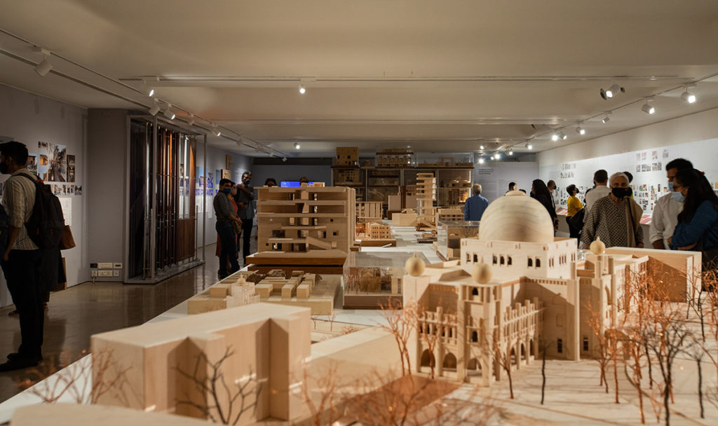 Interior of exhibition on RMA Architects with architecture models on a long table