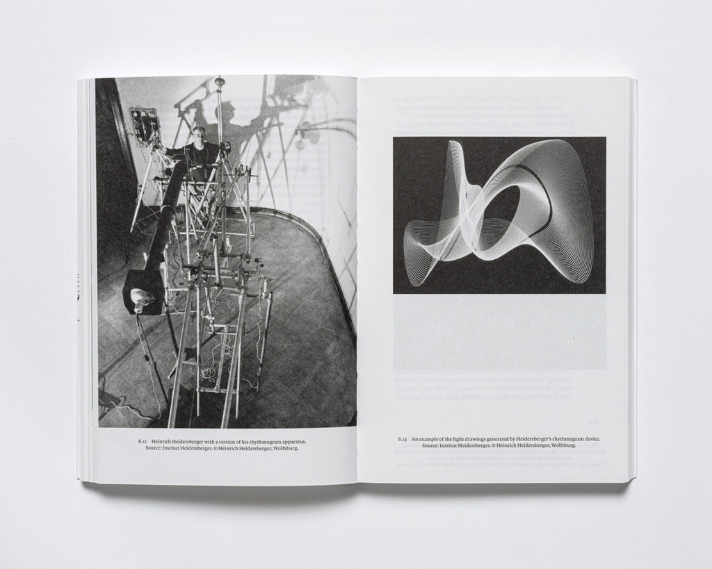 Book spread featuring black and white images of a machine and an abstract design.