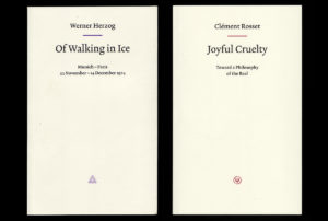 Flat-lay of two white book covers, title "Walking on Ice" and "Joyful Cruelty." Set on black background.