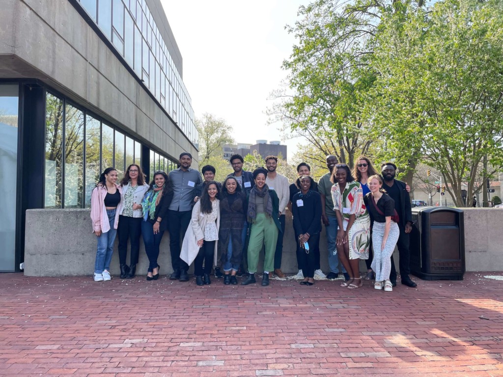 Black in Design mentees and mentors pose outside Gund Hall on a spring day.