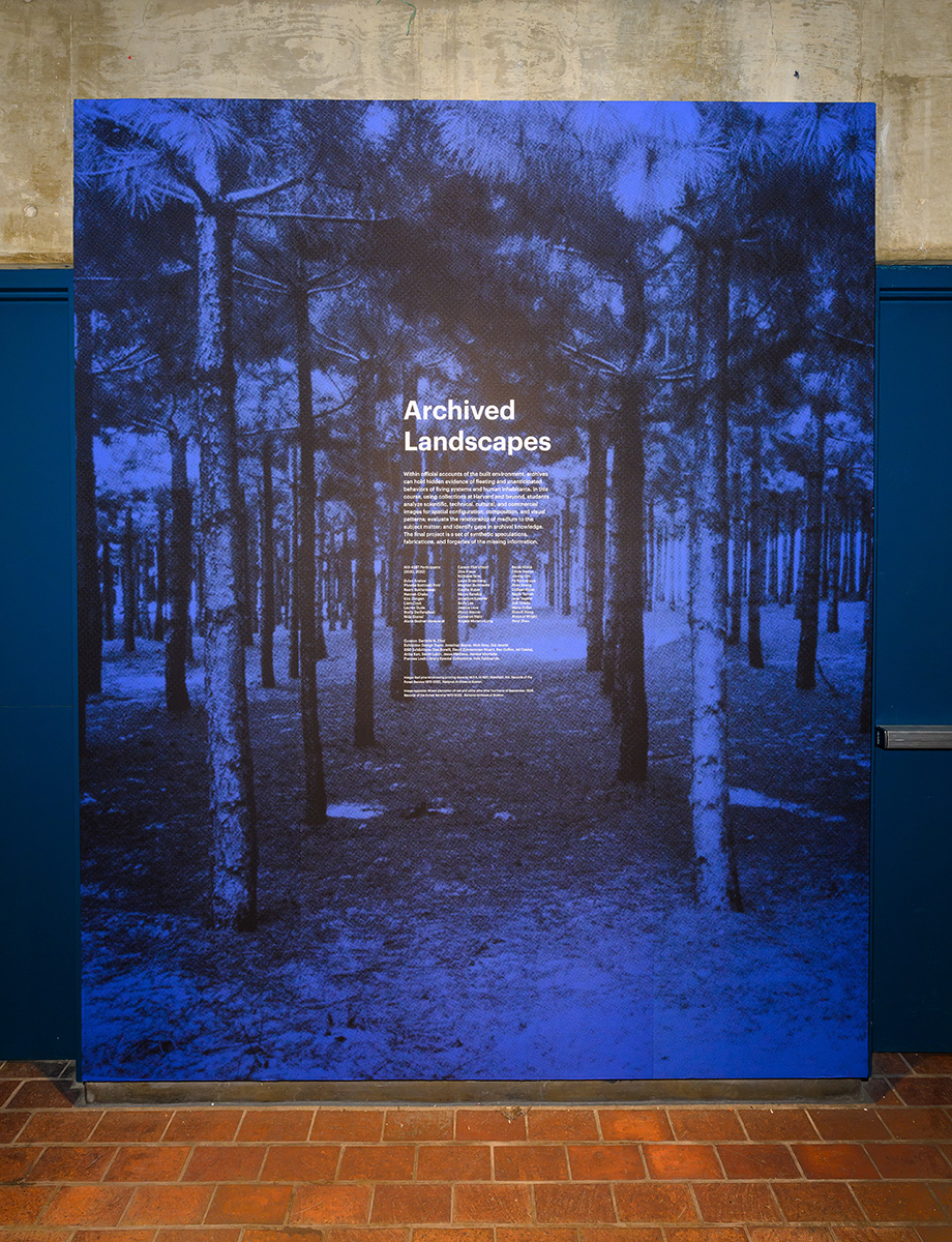 A blue and black wall mural of trees with the title “Archived Landscapes”