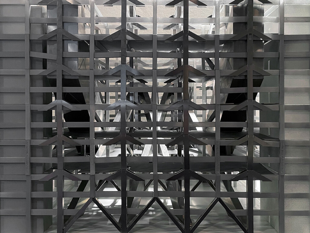 A three-dimentional open grid-like structure made of metal and other materials.